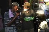Students provide sanitizers to daily workers to fight virus