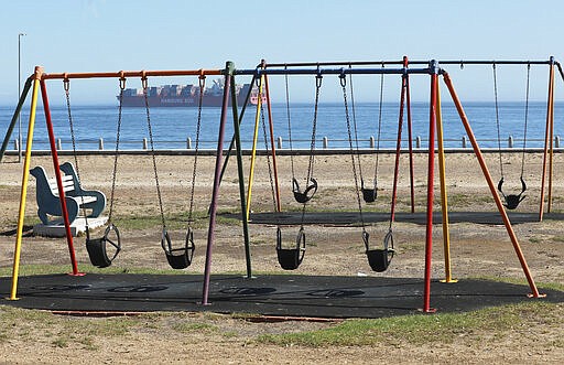 A view of the empty popular Sea Point promenade in Cape Town, South Africa, Saturday, March 28, 2020, on the second day of South Africa's nationwide lockdown in an effort to control the spread of the coronavirus. The new coronavirus causes mild or moderate symptoms for most people, but for some, especially older adults and people with existing health problems, it can cause more severe illness or death. (AP Photo/Nardus Engelbrecht)