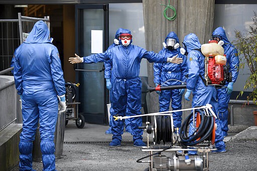 Members of a Russian team sanitize a hospice for elderly people to contain the spread of the Covid-19 virus, in Albino, near Bergamo, northern Italy, Saturday, March 28, 2020. The new coronavirus causes mild or moderate symptoms for most people, but for some, especially older adults and people with existing health problems, it can cause more severe illness or death. (Claudio Furlan/LaPresse via AP)