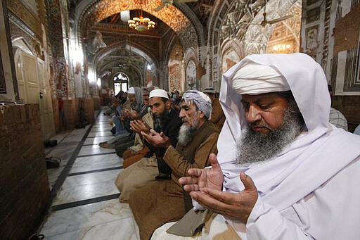 Pakistani worshippers attend a Friday prayers in Peshawar, Pakistan, Friday, March 27, 2020.  Authorities imposed nation-wide lockdown and appealed to people to avoid public gatherings as a preventive measure to contain the spread of coronavirus. The virus causes mild or moderate symptoms for most people, but for some, especially older adults and people with existing health problems, it can cause more severe illness or death.(AP Photo/Muhammad Sajjad)