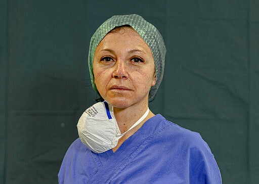 In this image taken on Friday, March 27, 2020, intensive care unit nurse Michela Pagati, 48, poses for a photo at the Brescia Spedali Civili Hospital, in Brescia, Italy. (AP Photo/Luca Bruno)