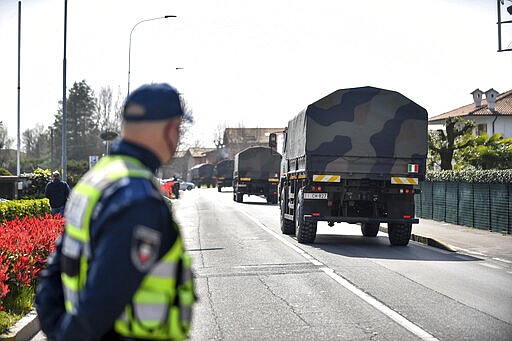 Military trucks carry coffins to be taken to crematoriums in Venice and Udine, from the San Giuseppe church in Seriate, near Bergamo, northern Italy, Saturday, March 28, 2020. The new coronavirus causes mild or moderate symptoms for most people, but for some, especially older adults and people with existing health problems, it can cause more severe illness or death. (Claudio Furlan/LaPresse via AP)