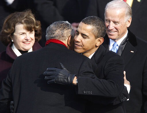 FILE - In this Jan. 20, 2009, file photo President Barack Obama embraces civil rights icon the Rev. Joseph E. Lowery during Obama's inauguration in Washington, as Sen. Dianne Feinstein, left, D-Calif., and Vice President Joe Biden watch. Lowery, a veteran civil rights leader who helped the Rev. Dr. Martin Luther King Jr. found the Southern Christian Leadership Conference and fought against racial discrimination, died Friday, March 27, 2020, a family statement said. He was 98. (Jim Bourg/Pool Photo via AP, File)