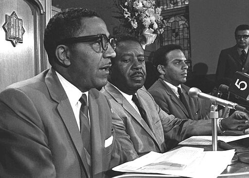 FILE - In this April 1968 file photo, the Rev. Ralph D. Abernathy, center, talks with aides, the Rev. Joseph E. Lowery, left, and the Rev. Andrew Young, during an Atlanta news conference. Lowery, a veteran civil rights leader who helped the Rev. Martin Luther King Jr. found the Southern Christian Leadership Conference and fought against racial discrimination, died Friday, March 27, 2020, a family statement said. He was 98. (AP Photo, File))