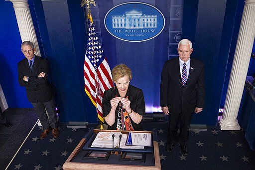 FILE - In this March 26, 2020, file photo Dr. Deborah Birx, White House coronavirus response coordinator, speaks about the coronavirus accompanied by Dr. Anthony Fauci, left, director of the National Institute of Allergy and Infectious Diseases, and Vice President Mike Pence, in the James Brady Briefing Room in Washington. Birx has emerged as one of the most important voices in the administration&#146;s response to the coronavirus pandemic, spelling out the implications of the virus in personal terms while attempting to reassure Americans that it is centering its response to the pandemic with a data-driven mindset. (AP Photo/Alex Brandon, File)