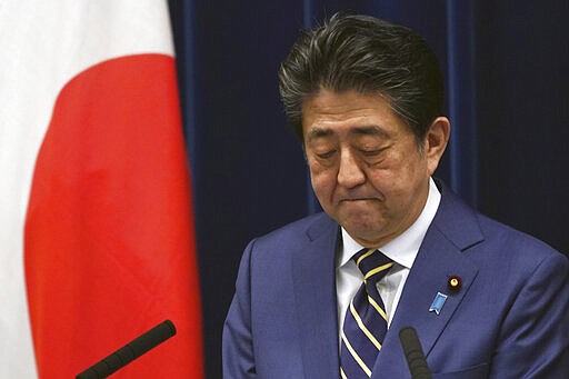 FILE - In this March 28, 2020, file, photo, Japanese Prime Minister Shinzo Abe bites his lips during his speech about the coronavirus situation in Japan at the prime minister's official residence in Tokyo. Before the Olympics were postponed, Japan looked like it had coronavirus infections contained, even as they spread in neighboring countries. Now that the games have been pushed to next year, Tokyo&#146;s cases are spiking, and the city's governor is requesting that people stay home, even hinting at a possible lockdown. (AP Photo/Eugene Hoshiko, File)