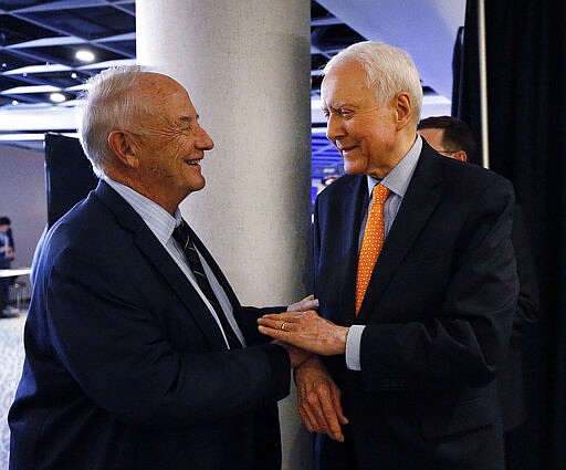 FILE - In this Nov. 6, 2018, file photo, Robert Garff, left, greets U.S. Sen. Orrin Hatch, R-Utah, during the UTGOP election night party in Salt Lake City. Robert Garff, 78, died Sunday, March 29, 2020, of coronavirus, his daughter said. (Ravell Call/The Deseret News via AP, File)