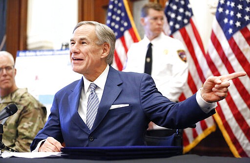 Texas Governor Greg Abbott announced new executive orders listing the US Army Corps of Engineers and the state are putting up a 250-bed field hospital at the Kay Bailey Hutchison Convention Center in downtown Dallas during a press conference at the Texas State Capitol in Austin, Sunday, March 29, 2020. The space can expand to nearly 1,400 beds. (Tom Fox/The Dallas Morning News via AP, Pool)