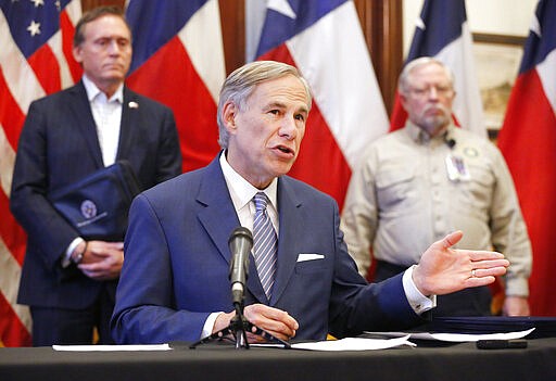 Texas Governor Greg Abbott announced the US Army Corps of Engineers and the state are putting up a 250-bed field hospital at the Kay Bailey Hutchison Convention Center in downtown Dallas during a press conference at the Texas State Capitol in Austin, Sunday, March 29, 2020. The space can expand to nearly 1,400 beds. Joining him was former State Representative Dr. John Zerwas (left) and Texas Department of State Health Services Commissioner John Hellerstedt, MD. (Tom Fox/The Dallas Morning News via AP, Pool)