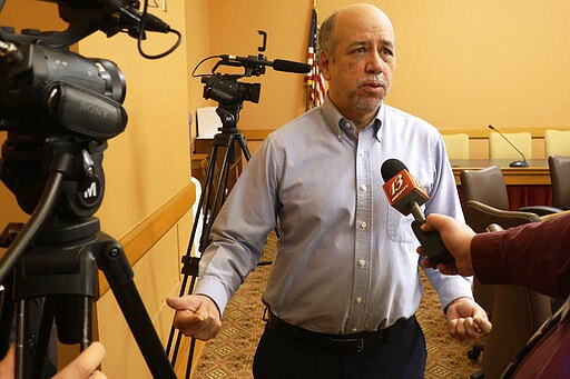 Kansas House Minority Leader Tom Sawyer, D-Wichita, speaks with reporters Sunday, March 29, 2020, at the Statehouse in Topeka, Kan. Leaders of the Republican-controlled Kansas Legislature agreed that Democratic Gov. Laura Kelly's statewide stay-at-home order is necessary to help check the spread of the new coronavirus, allowing it to take effect Monday as planned. (AP Photo/John Hanna)