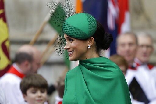 Britain's Meghan the Duchess of Sussex receives flowers as she leaves after attending the annual Commonwealth Day service at Westminster Abbey in London, Monday, March 9, 2020. The annual service, organised by the Royal Commonwealth Society, is the largest annual inter-faith gathering in the United Kingdom. (AP Photo/Kirsty Wigglesworth)