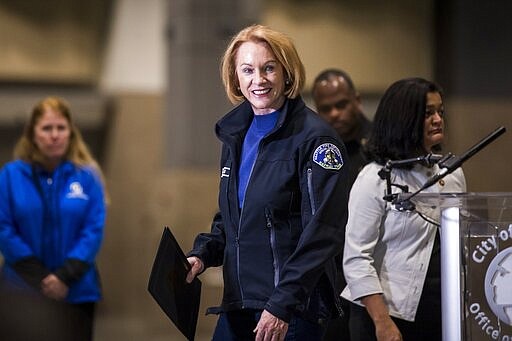 Seattle Mayor Jenny Durkan hands off the mic during a press conference at CenturyLink Field Event Center on Saturday, March 28, 2020, in Seattle, Wash.. (Amanda Snyder/The Seattle Times via AP, Pool)