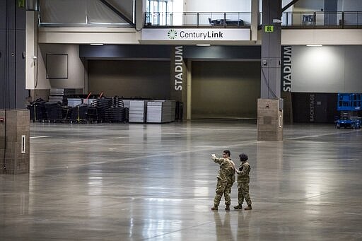 Army officials plan the development of a field hospital at CenturyLink Field Event Center on Saturday, March 28, 2020. This field hospital will include 300 soldiers from the 627th Army Hospital from Fort Carson, Colorado deployed to Seattle to staff the hospital. It is is expected to create at least 150 hospital beds for non-COVID-19 cases. (Amanda Snyder/The Seattle Times via AP, Pool)