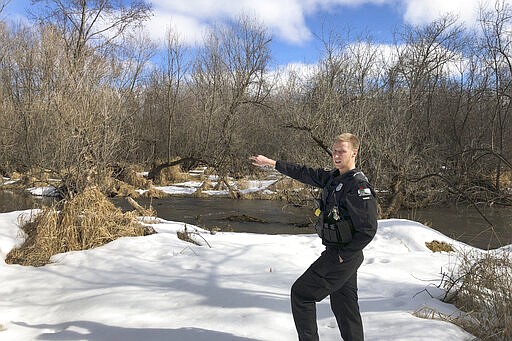 In this March 5, 2020 photo, Wisconsin Department of Natural Resources Warden Austin Schumacher stands on the edge of a marsh in Edgerton, Wis., where a 13-year-old boy disappeared after running away from school in November 2019. Schumacher used old-school tracking skills to find and rescue the child moments before a snowstorm struck. This month, Schumacher received the DNR&#146;s Lifesaving Award.  (AP Photo/Todd Richmond)