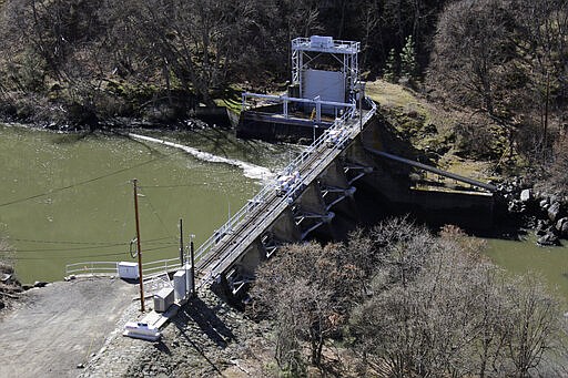 In this March 3, 2020, photo, a dam on the lower Klamath River known as Copco 2 is seen near Hornbrook, Calif. A plan to demolish four dams on California's second-largest river to benefit threatened salmon has sharpened a decades-old dispute over who has the biggest claim to the river's life-giving waters. The project, if it goes forward, would be the largest dam demolition project in U.S. history and would include the Copco 2 facility pictured. (AP Photo/Gillian Flaccus)