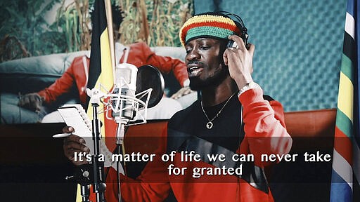 This image made from video is a frame from the latest music video of Bobi Wine, whose real name is Kyagulanyi Ssentamu, showing the singer recording an informational music video educating the public about the dangers of the new coronavirus and the precautionary measures they should take to fight its spread. Wine, who released a song in March 2020 urging Africa's people to wash their hands to stop the spread of the new coronavirus, is criticizing African governments for not maintaining better health care systems for the continent's 1.3 billion people while investing in weapons and &quot;curtailing the voices of the people&quot;. (Bobi Wine via AP)