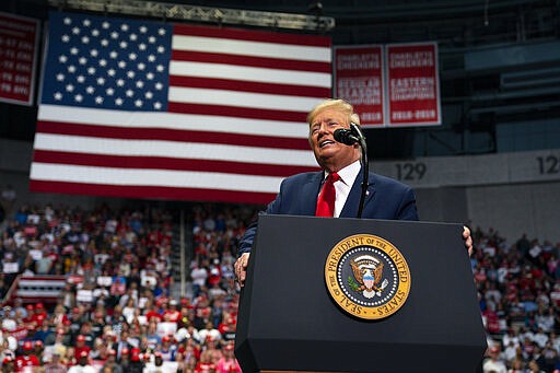 FILE - In this March 2, 2020, file photo President Donald Trump speaks during a campaign rally at Bojangles Coliseum in Charlotte, N.C. White House contenders aren't typically bashful about asking for money. But as the coronavirus pandemic upends life, Trump and his likely Democratic rival, Joe Biden, suddenly find themselves navigating perilous terrain. (AP Photo/Evan Vucci, File)