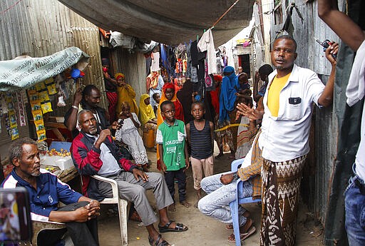 In this photo taken Thursday, March 26, 2020, residents live in crowded conditions in the Sayidka camp for internally displaced people in Mogadishu, Somalia. The country has only a handful of confirmed cases of the new coronavirus so far but residents of the camp, who have already fled drought and violence from the Islamist al-Shabab militant group, say they are fearful of the virus and feel vulnerable. (AP Photo/Farah Abdi Warsameh)