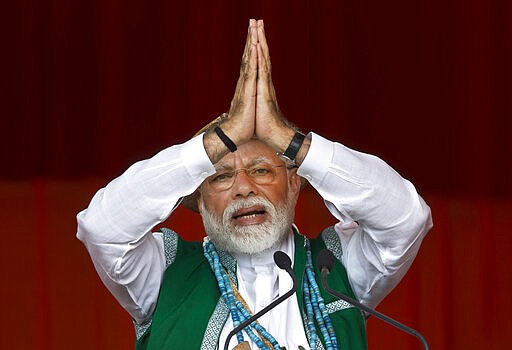 FILE- In this March 30, 2019 file photo, Indian Prime Minister Narendra Modi gestures as he speaks during an election campaign rally of his Bharatiya Janata Party (BJP) in Along, Arunachal Pradesh, India. Modi on Sunday apologized to the country&#146;s public for imposing the ongoing world's largest lockdown for three weeks, calling it harsh but &#147;needed to win&#148; the battle against coronavirus pandemic. (AP Photo/Anupam Nath, File)