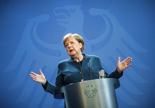 German Chancellor Angela Merkel speaks at a press conference about coronavirus, in Berlin, Sunday, March 22, 2020. German Chancellor Angela Merkel has gone into quarantine after being informed that a doctor who administered a vaccine to her has tested positive for the new coronavirus.Merkel's spokesman said the German chancellor was informed about the doctor's test shortly after holding a news conference Sunday announcing new measures to curb the spread of the virus. For most people, the new coronavirus causes only mild or moderate symptoms. For some it can cause more severe illness. (Michael Kappeler/Pool photo via AP)