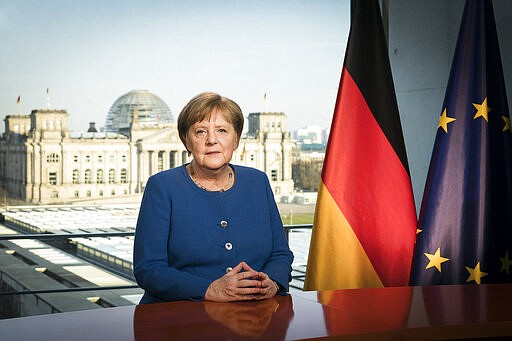 In this photo provide by the German government, German Chancellor Angela Merkel poses for a photo during the recording of her first direct TV address to the nation in over 14 years in power, at the chancellery in Berlin, Germany, Wednesday, March 18, 2020. For most people, the new coronavirus causes only mild or moderate symptoms, such as fever and cough. For some, especially older adults and people with existing health problems, it can cause more severe illness, including pneumonia. (Bundesregierung/Steffen Kugler via AP)