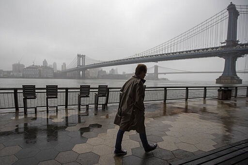 A man walk alone on the promenade under the FDR drive in Lower Manhattan, Sunday, March 29, 2020. The new coronavirus causes mild or moderate symptoms for most people, but for some, especially older adults and people with existing health problems, it can cause more severe illness or death. (AP Photo/Mary Altaffer)