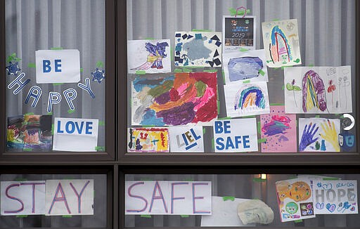 Signs of support are shown on a window in Montreal, Sunday, March 29, 2020, as Coronavirus COVID-19 cases rise in Canada and around the world. (Graham Hughes/The Canadian Press via AP)