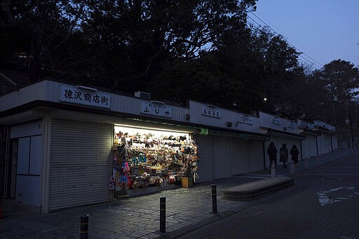 Tadayuki Takiguchi's souvenir shop remains open in Nara, Japan, March 17, 2020. Nara was among the first Japanese town hit by the COVID-19 in late January, when a tour bus driver in town tested positive for the virus, becoming the first Japanese patient after carrying tourists from Wuhan, the epicenter of the pandemic. (AP Photo/Jae C. Hong)