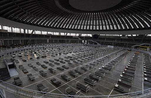 In this March 24, 2020, photo, Serbian soldiers set up beds for treatment of possible COVID-19 infected patients inside of the Belgrade Fair, Serbia. In the ex-communist Europe and elsewhere, rulers are assuming more power while they introduce harsh measures they say are necessary to halt coronavirus spread.&#160;(AP Photo/Darko Vojinovic)