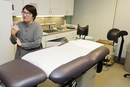 FILE - In this Feb. 25, 2020, file photo, Executive Director Chrisse France talks about Preterm, the busiest abortion clinic in Ohio, in the procedure room in Cleveland. The governor and attorney general of Texas are moving to ban most abortions in the state during the coronavirus outbreak, declaring they don't qualify as essential surgeries. (AP Photo/Tony Dejak, File)