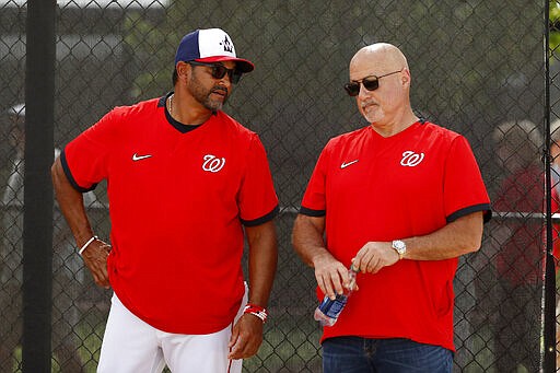 Washington Nationals manager Dave Martinez, left, talks with general manager Mike Rizzo during spring training baseball practice Monday, Feb. 17, 2020, in West Palm Beach, Fla. (AP Photo/Jeff Roberson)