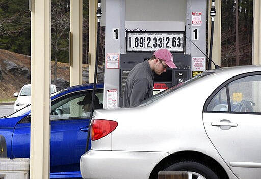 Brad Downey fills up his vehicle at the Stop &amp; Shop gas station in Pittsfield, Mass. where regular unleaded gasoline was $1.89 gallon on Monday, March 30, 2020. (Gillian Jones/The Berkshire Eagle via AP)