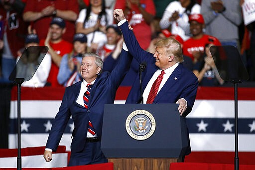 FILE - In this Feb. 28, 2020 file photo, Sen. Lindsey Graham, R-S.C., left, stands onstage with President Donald Trump during a campaign rally,  in North Charleston, S.C. The filing period for South Carolina&#146;s 2020 primaries and November general election closed Monday, March 30 although the coronavirus outbreak has left in flux how exactly the elections will be carried out. Perhaps the most highly anticipated election contest coming up in South Carolina is Graham&#146;s pursuit of a fourth term in office. A general election matchup with Democrat Jaime Harrison all but certain, Graham has also drawn a handful of Republican challengers, as well as Constitution and Libertarian party opponents.   (AP Photo/Patrick Semansky, File)