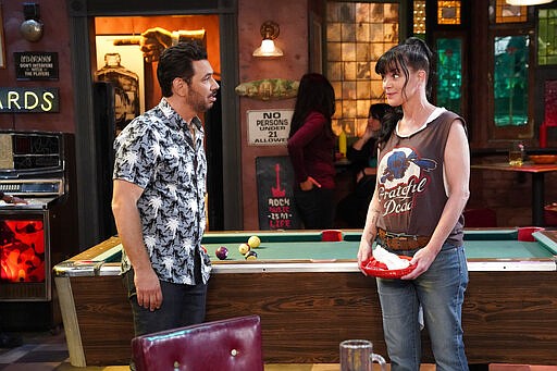 This image released by CBS shows Al Madrigal, left, and Pauley Perrette in a scene from the comedy &quot;Broke,&quot; debuting on Thursday at 9:30 p.m. EDT. (Greg Gayne/CBS via AP)