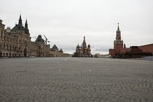 A view of an empty Red square, with the St. Basil's Cathedral, center, and Kremlin's Spasskaya Tower, right, in Moscow, Russia, Monday, March 30, 2020. Moscow Mayor Sergei Sobyanin ordered all city residents except for those working in essential sectors to stay home starting Monday. Residents are allowed to buy food and medicines at nearby stores and pharmacies and walk their dogs in close vicinity. (AP Photo/Pavel Golovkin)