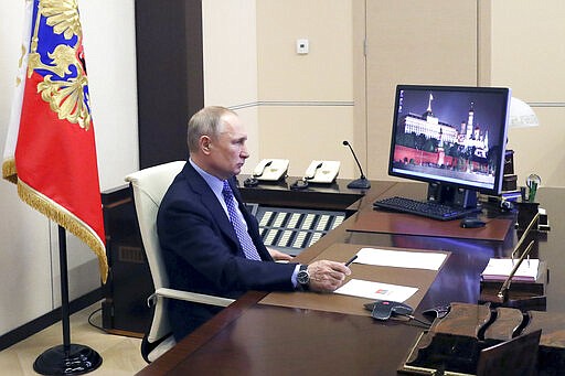 Russian President Vladimir Putin chairs a meeting with Russian regional officials via videoconference at the Novo-Ogaryovo residence outside Moscow, Russia, Monday, March 30, 2020. Putin says the country has managed to slow down the spread of coronavirus but should be prepared for contagions to grow quickly. The new coronavirus causes mild or moderate symptoms for most people, but for some, especially older adults and people with existing health problems, it can cause more severe illness or death. (Mikhail Klimentyev, Sputnik, Kremlin Pool Photo via AP)