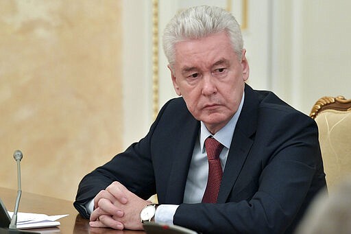 Moscow Mayor Sergei Sobyanin attends a cabinet meeting with Russian Prime Minister Mikhail Mishustin in Moscow, Russia, Monday, March 30, 2020. Sobyanin ordered a lockdown starting Monday requesting all city residents except those working in essential sectors to stay home except in cases of medical emergency and shop only at nearby stores or pharmacies. The new coronavirus causes mild or moderate symptoms for most people, but for some, especially older adults and people with existing health problems, it can cause more severe illness or death. (Alexander Astafyev, Sputnik, Kremlin Pool Photo via AP)