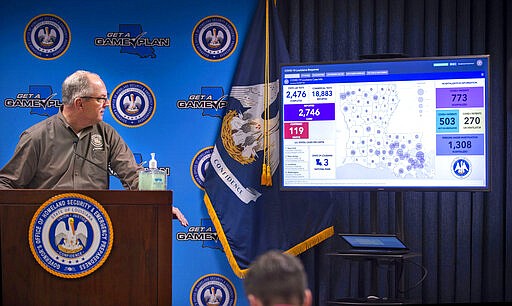 Louisiana Gov. John Bel Edwards looks at a monitor displaying the state's evolving novel coronavirus COVID-19 situation, at the start of a press conference, Friday, March 27, 2020 at the Governor's Office of Homeland Security &amp; Emergency Management in Baton Rouge, La. (Travis Spradling/The Advocate via AP, Pool)