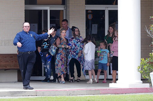 Congregants exit after services at the Life Tabernacle Church in Central, La., Sunday, March 29, 2020. Pastor Tony Spell has defied a shelter-in-place order by Louisiana Gov. John Bel Edwards, due to the new coronavirus pandemic, and continues to hold church services with hundreds of congregants. (AP Photo/Gerald Herbert)