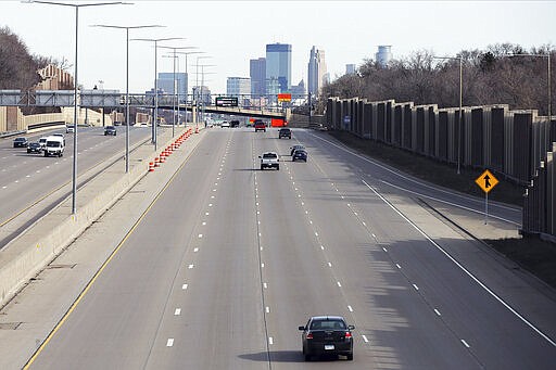 Traffic on Interstate 35 leading into Minneapolis is sparse Monday morning, March 30, 2020, as an executive stay at home order issued by Minnesota Gov. Tim Walz is in force in an effort to slow down the coronavirus in the state. The new coronavirus causes mild or moderate symptoms for most people, but for some, especially older adults and people with existing health problems, it can cause more severe illness or death. (AP Photo/Jim Mone)