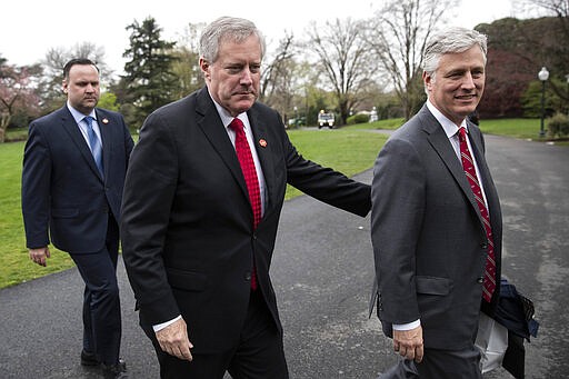 White House Social Media Director Dan Scavino, left, Acting White House Chief of Staff Mark Meadows, and National Security Adviser Robert O'Brien, walk to the West Wing as they return to the White House, Saturday, March 28, 2020, in Washington. President Donald Trump is returning from Norfolk, Va., for the sailing of the USNS Comfort, which is headed to New York. (AP Photo/Alex Brandon)