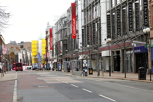 Deserted streets due to the coronavirus restrictions in Belfast city centre, Northern Ireland, Monday, March, 30, 2020. The new coronavirus causes mild or moderate symptoms for most people, but for some, especially older adults and people with existing health problems, it can cause more severe illness of death. (AP Photo/Peter Morrison)