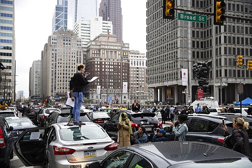 Protesters call for officials to release people from jails, prisons, and immigration detention centers in response to the coronavirus, as they block traffic outside City Hall in Philadelphia, Monday, March 30, 2020. (AP Photo/Matt Rourke)