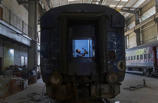 An Indian railway employee works to convert a train coach into an isolation ward for the fight against the new coronavirus in Gauhati, India, Sunday, March 29, 2020. Indian Prime Minister Narendra Modi apologized to the public on Sunday for imposing a three-week national lockdown, calling it harsh but &quot;needed to win&quot; the battle against the coronavirus pandemic. The new coronavirus causes mild or moderate symptoms for most people, but for some, especially older adults and people with existing health problems, it can cause more severe illness or death. (AP Photo/Anupam Nath)