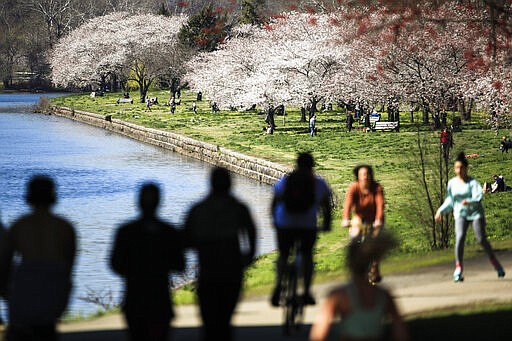 FILE - In this March 26, 2020, file photo, people exercise on the trail along Kelly Drive in Philadelphia. For millions of seasonal allergy sufferers, the annual onset of watery eyes and scratchy throats is bumping up against the global spread of a new virus that produces its own constellation of respiratory symptoms. That&#146;s causing angst for people who suffer from hay fever and are now asking themselves whether their symptoms are related to their allergies or the new coronavirus. (AP Photo/Matt Rourke, File)