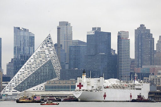 The Navy hospital ship USNS Comfort docks in New York, Monday, March 30, 2020. The ship has 1,000 beds and 12 operating rooms that could be up and running within 24 hours of its arrival on Monday morning. It's expected to bolster a besieged health care system by treating non-coronavirus patients while hospitals treat people with COVID-19. (AP Photo/Seth Wenig)