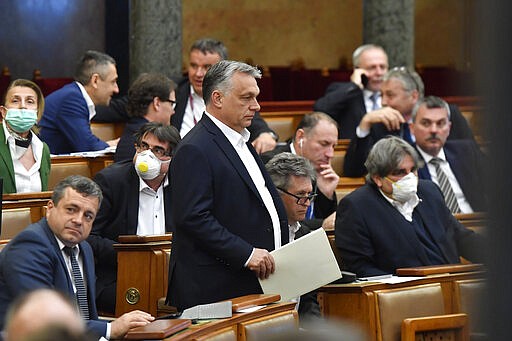 Hungarian Prime Minister Viktor Orban arrives for the plenary session of the Parliament in Budapest, Hungary, Monday, March 30, 2020. Later MPs approved legislation that extends a state of emergency and gives the government extraordinary powers to enact measures to contain the spread of the novel coronavirus.  The new coronavirus causes mild or moderate symptoms for most people, but for some, especially older adults and people with existing health problems, it can cause more severe illness or death. (Zoltan Mathe/MTI via AP)