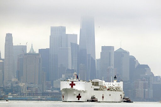 The Navy hospital ship USNS Comfort passes lower Manhattan on its way to docking in New York, Monday, March 30, 2020. The ship has 1,000 beds and 12 operating rooms that could be up and running within 24 hours of its arrival on Monday morning. It's expected to bolster a besieged health care system by treating non-coronavirus patients while hospitals treat people with COVID-19. AP Photo/Seth Wenig)