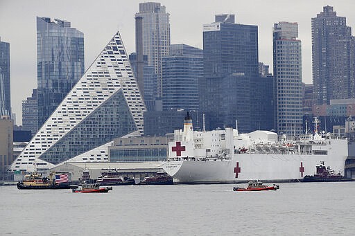 The Navy hospital ship USNS Comfort docks in New York, Monday, March 30, 2020. The ship has 1,000 beds and 12 operating rooms that could be up and running within 24 hours of its arrival on Monday morning. It's expected to bolster a besieged health care system by treating non-coronavirus patients while hospitals treat people with COVID-19. (AP Photo/Seth Wenig)