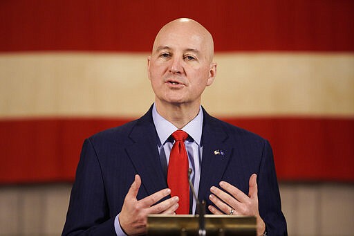 Nebraska Gov. Pete Ricketts speaks at a press briefing in Lincoln, Neb., Wednesday, March 25, 2020. Nebraska approved an $83.6 million emergency relief package Wednesday to help public health officials respond to new coronavirus as the number of cases continued to rise and Gov. Pete Ricketts expanded the list of counties where restaurants and bars will be forced to close their dining areas. (AP Photo/Nati Harnik)